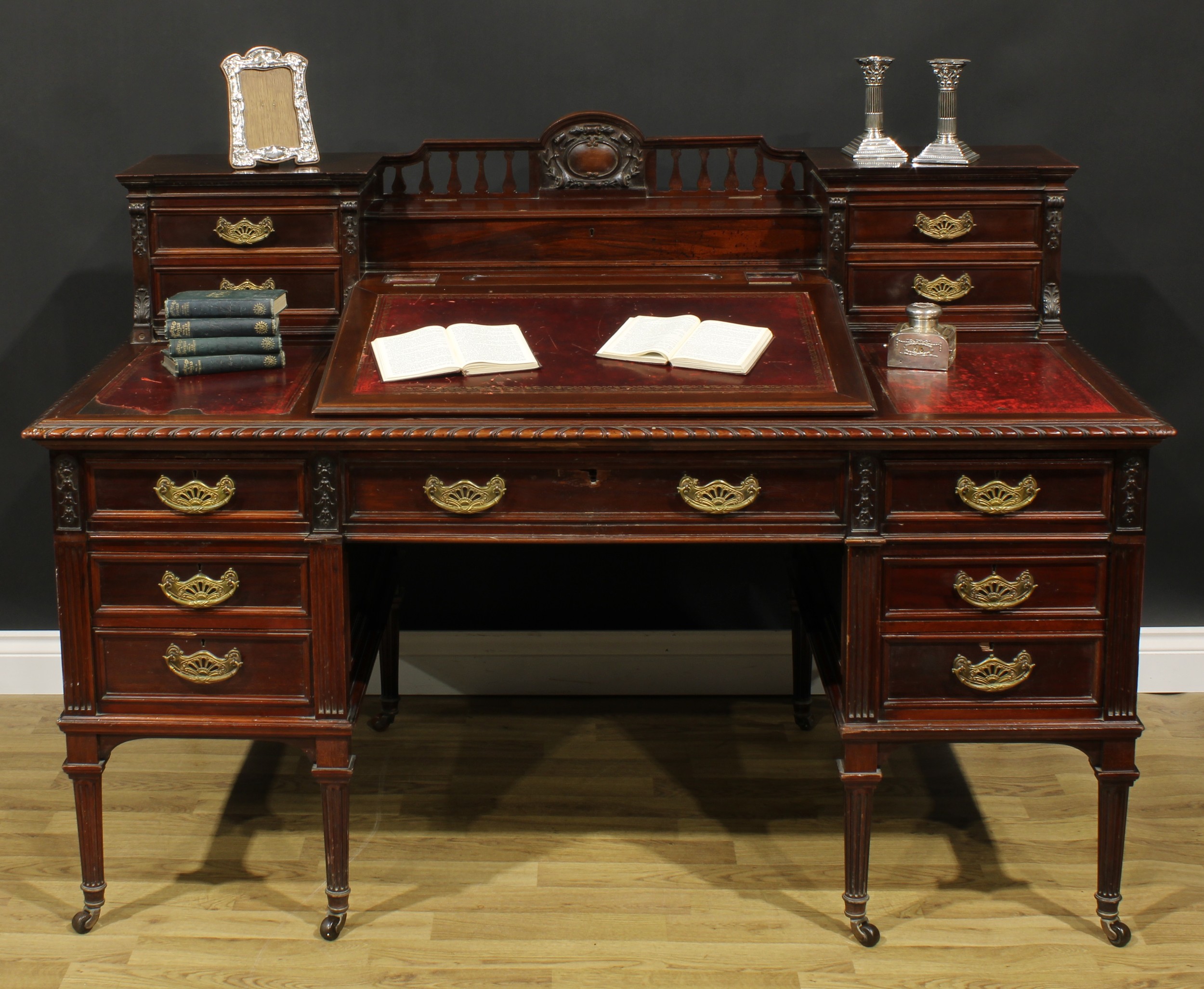 A late Victorian mahogany twin pedestal Dickens desk, shaped superstructure with hinged covered