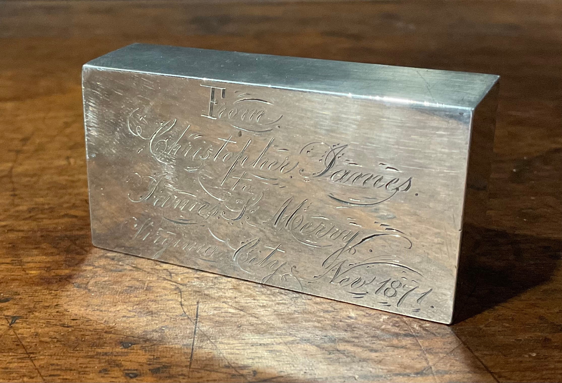 A late 19th century American silver ingot or desk weight, "From Christopher James to James S