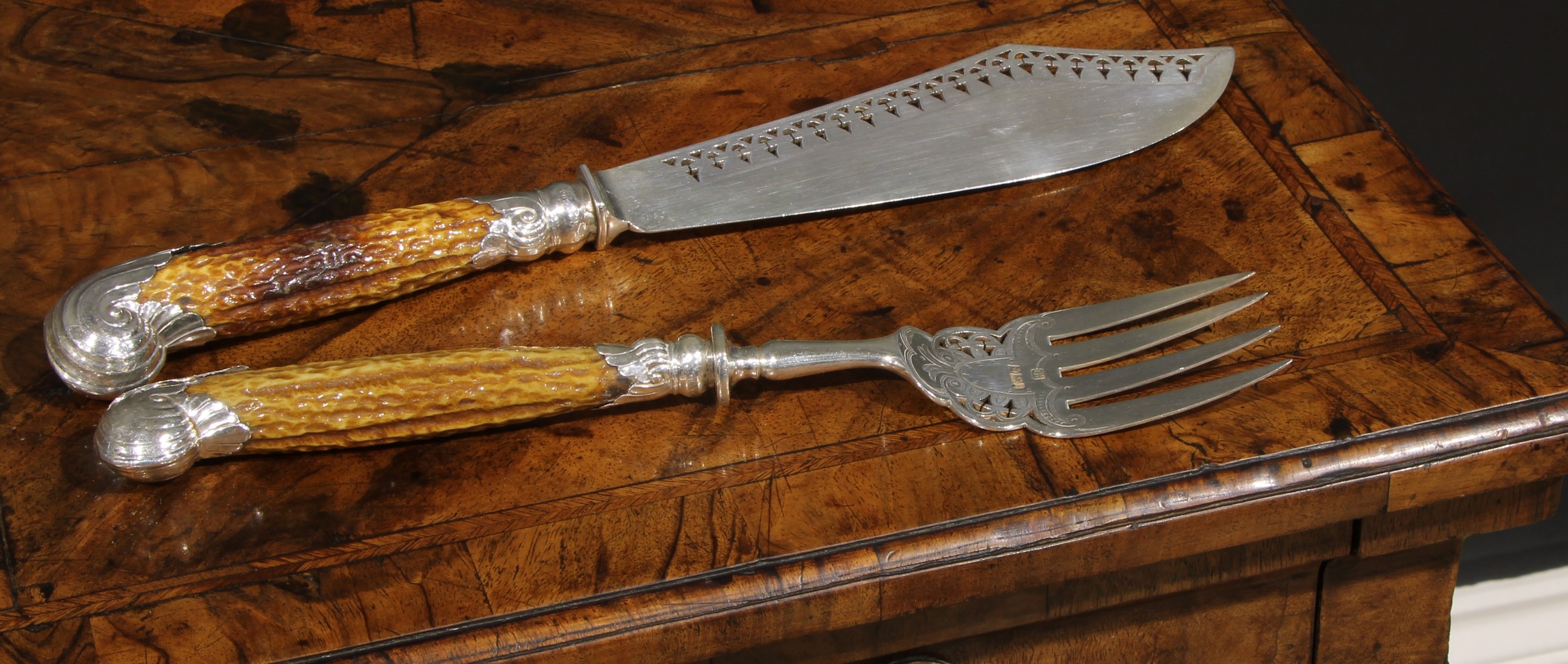 A pair of late Victorian silver country house fish servers, pierced and wriggle-work engraved