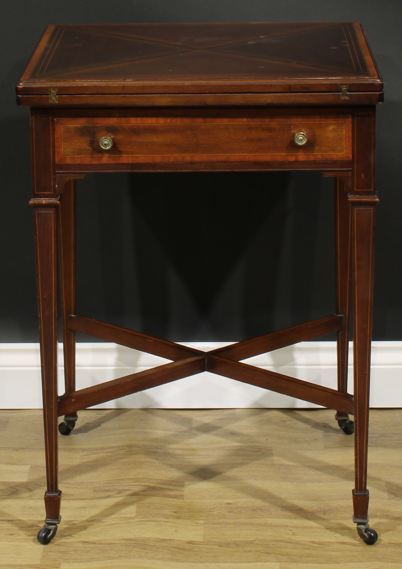 An Edwardian satinwood crossbanded mahogany envelope card table, hinged top enclosing a baize