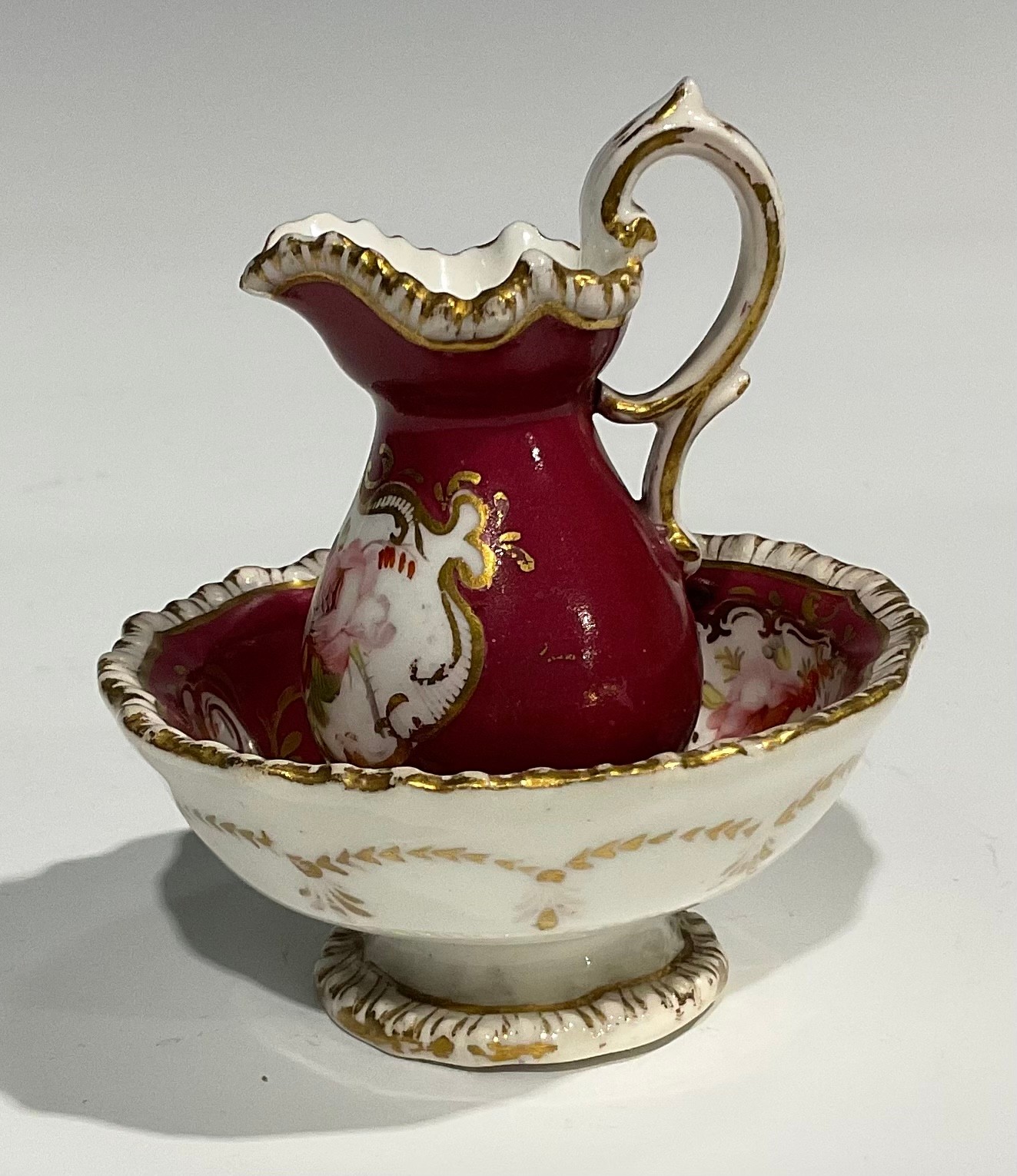 An English porcelain miniature jug and bowl, probably Rockingham, painted with flowers on a green - Image 11 of 12