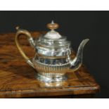 A George III silver half-fluted bachelor's teapot, hinged cover, scroll-capped handle, skirted base,