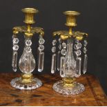 A pair of 19th century gilt bronze and clear glass candle lustres, each with fluted campana sconce