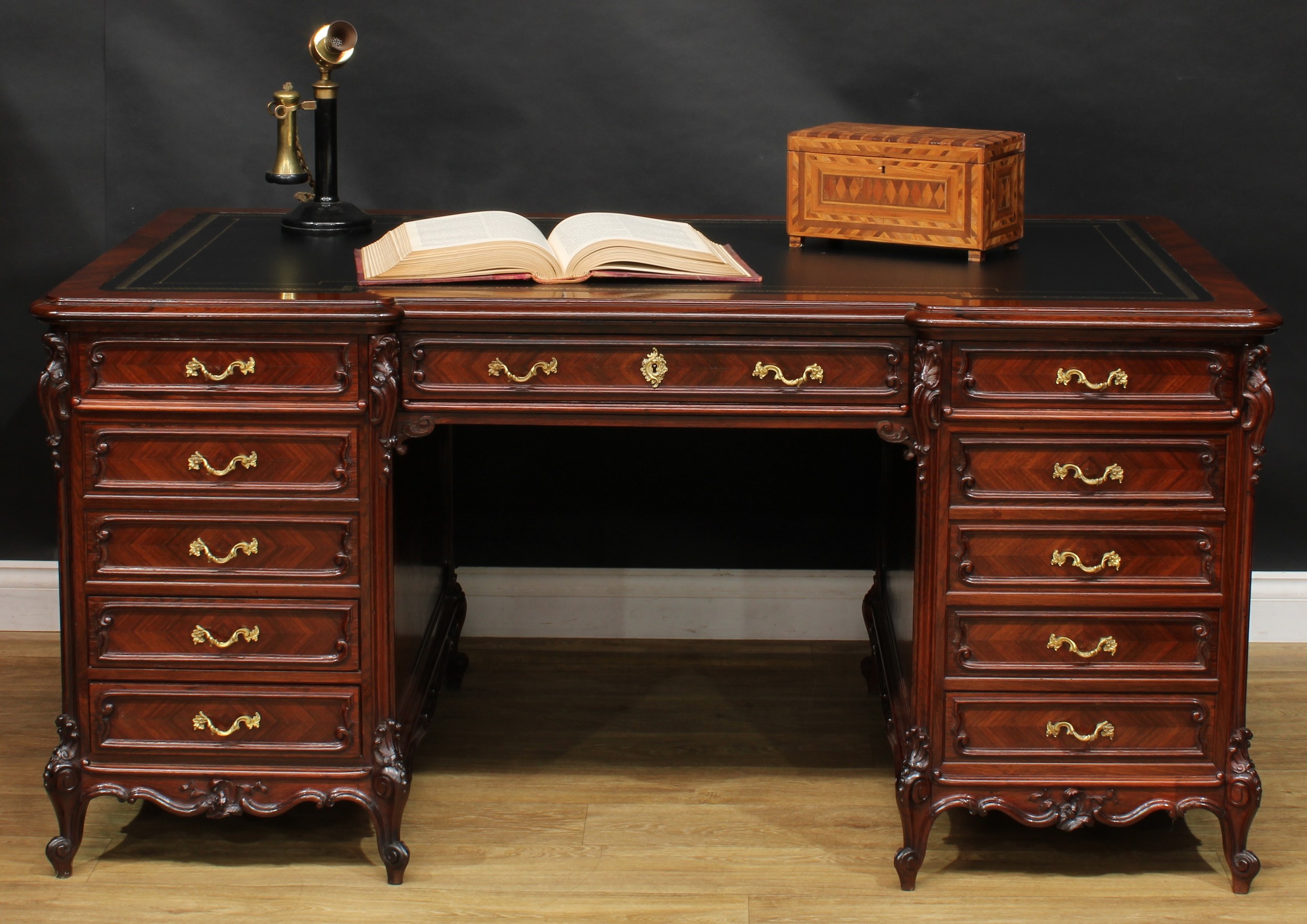 A late 19th century French rosewood and kingwood twin pedestal desk, inverted break-centre top