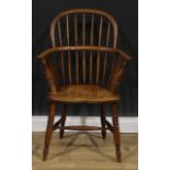 A 19th century ash and elm Windsor elbow chair, low hoop back, saddle seat, H-stretcher, 95cm