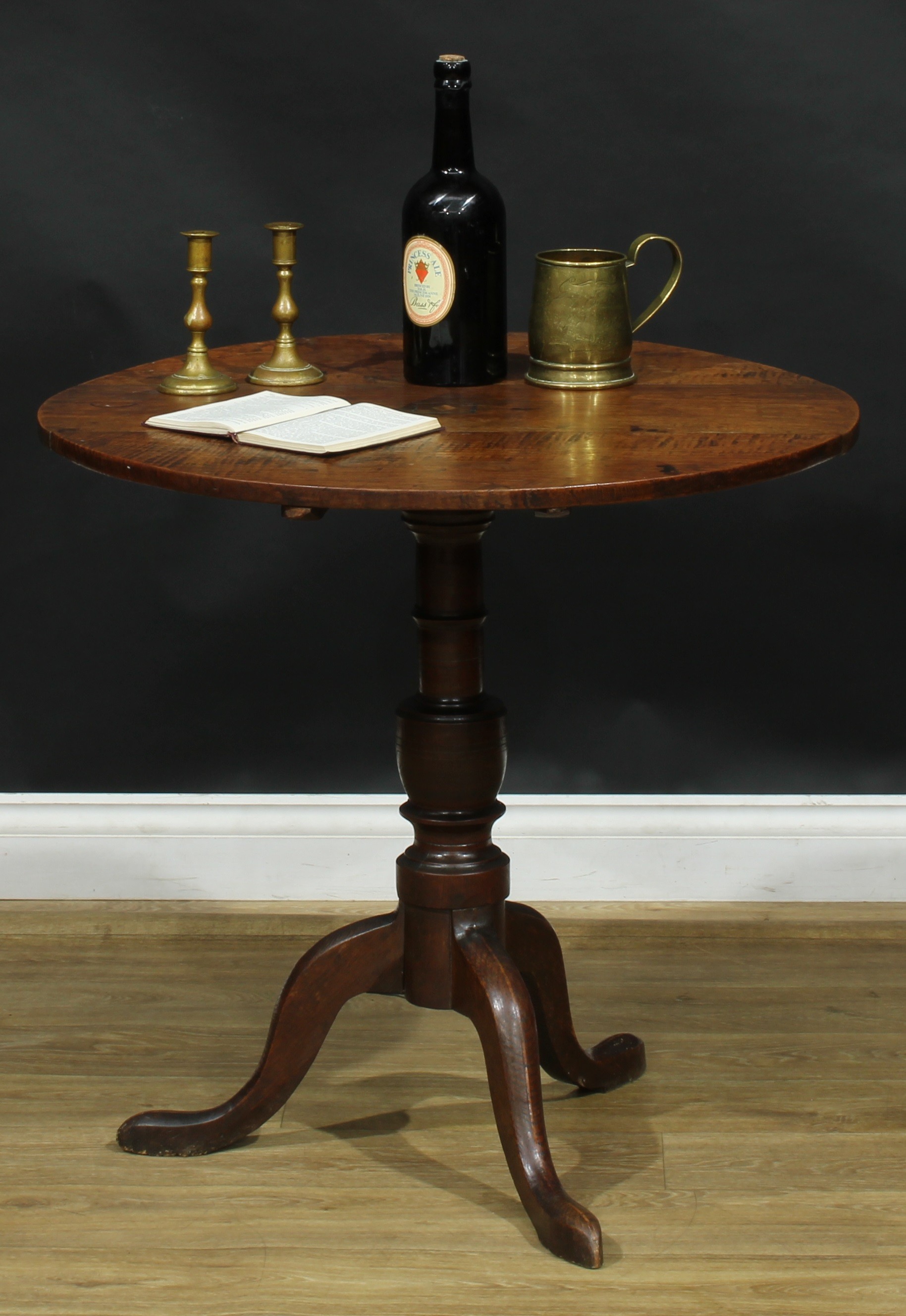 A George III elm and oak tripod occasional table, fixed near-circular top centred by a featherbanded