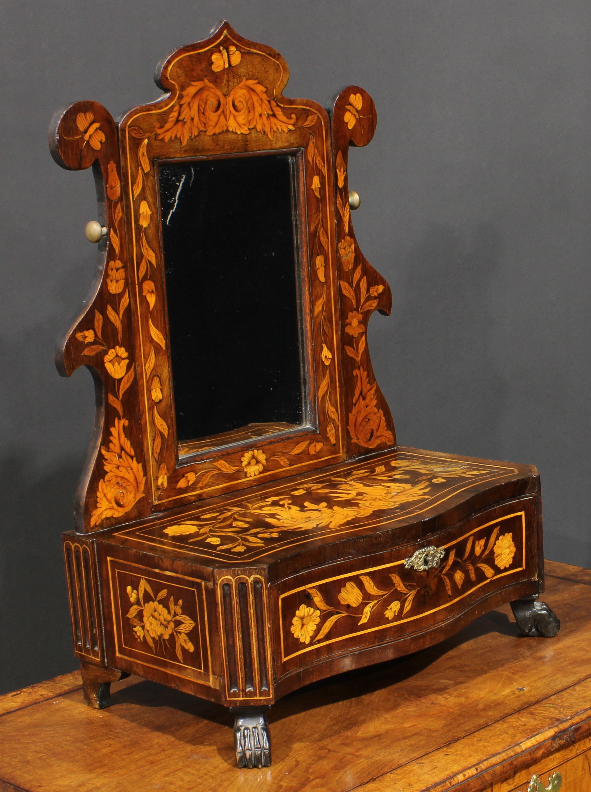 A 19th century Dutch marquetry dressing mirror, serpentine-front base with a long drawer, paw