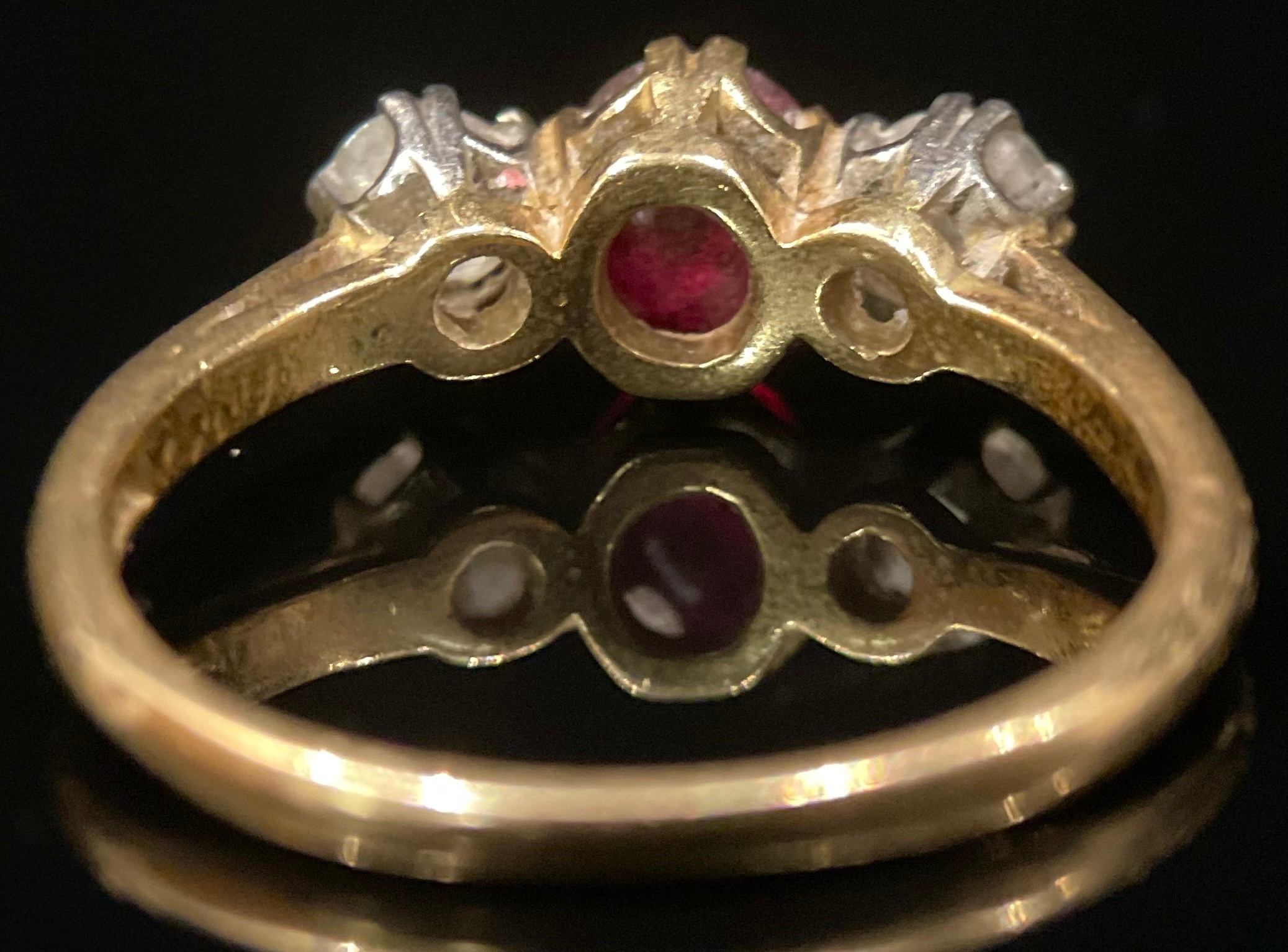 A diamond, rub and 18ct gold three stone ring, the central ruby flanked by a pair of round brilliant - Image 3 of 3