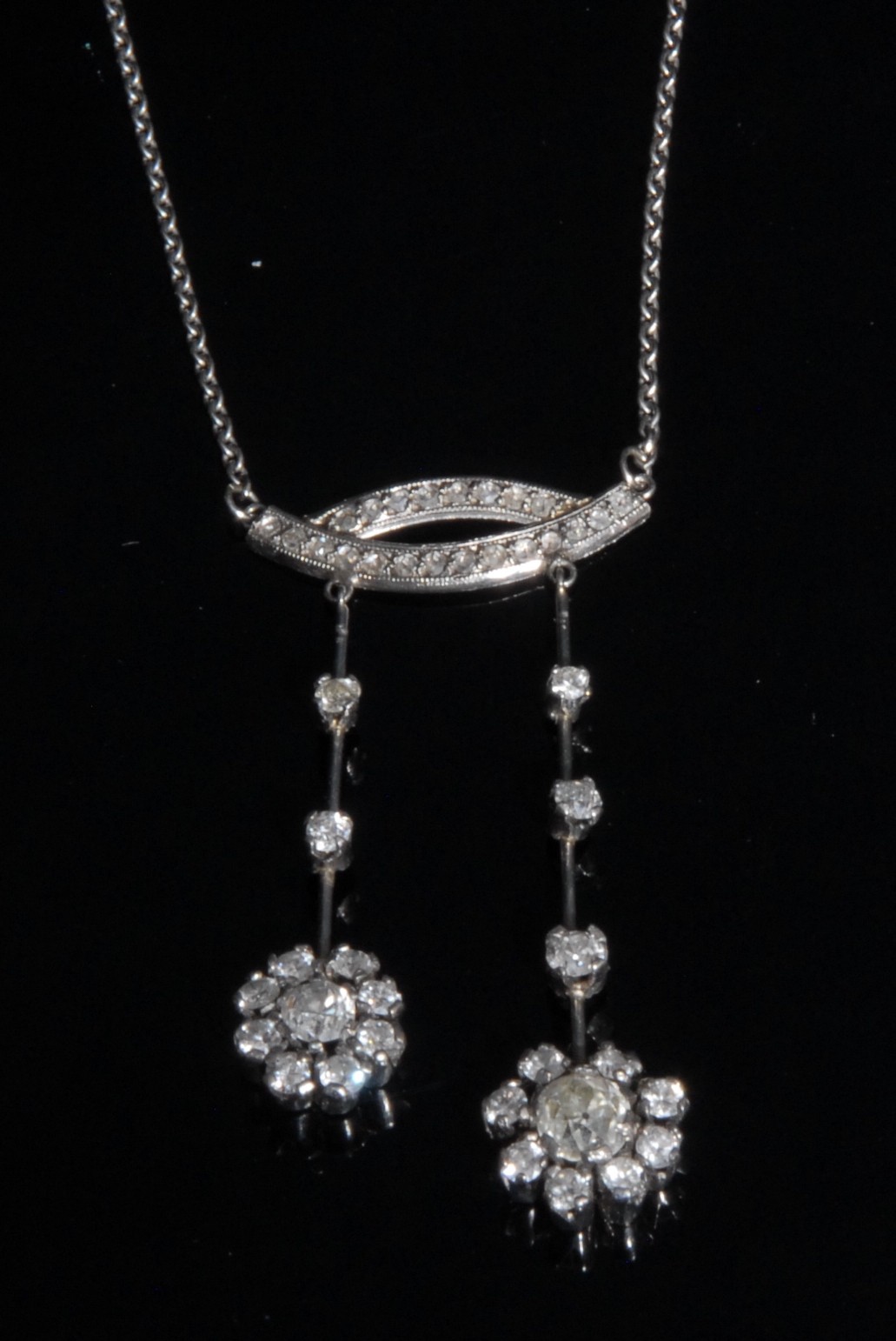 A late Victorian /Edwardian diamond pendant necklace, the two floral drops, inset with forty four