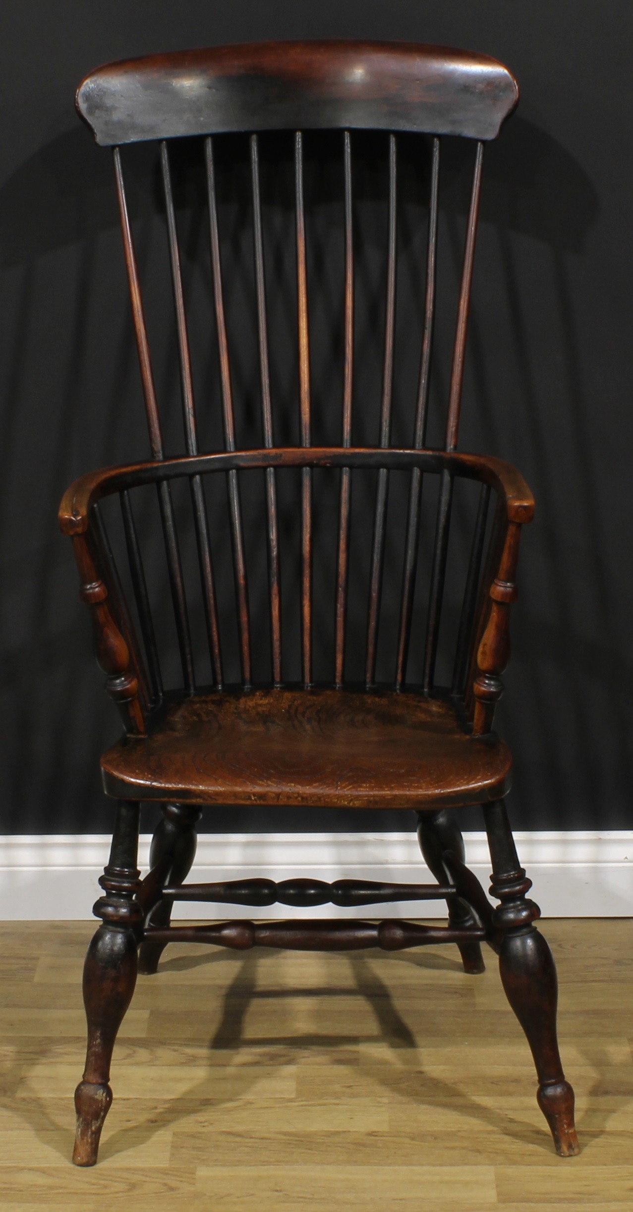 A 19th century fruitwood, elm, ash and beech Windsor elbow chair, tall tapered stick back, turned