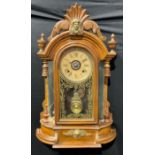 An early 20th century American gingerbread form mantel clock, by the Ansonia Clock Co., New York,