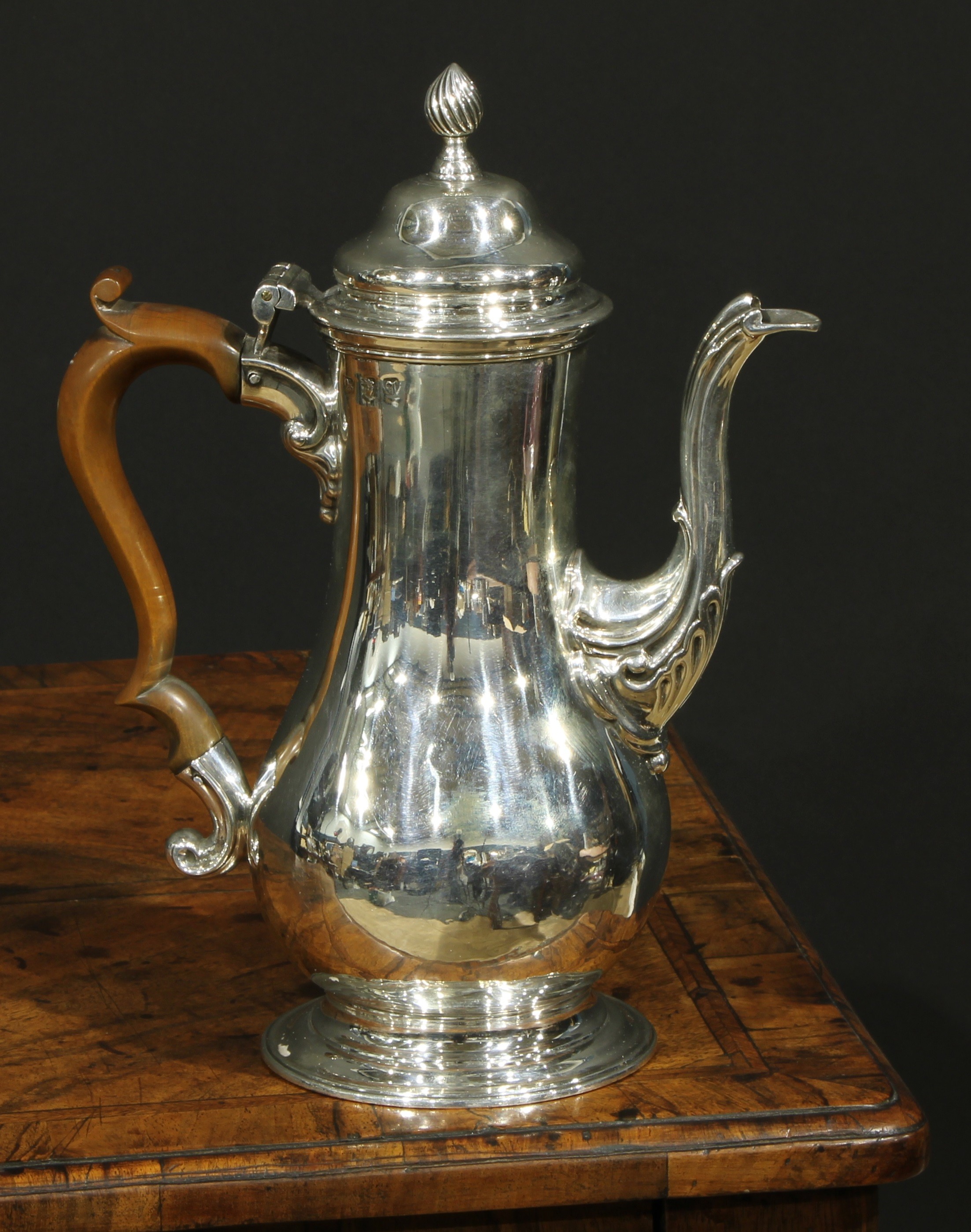 An early George III silver baluster pedestal coffee pot, hinged domed cover with spiral knop finial,