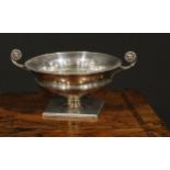 A George V silver Regency style two handled campana shaped sweetmeat dish, the divided acanthus leaf
