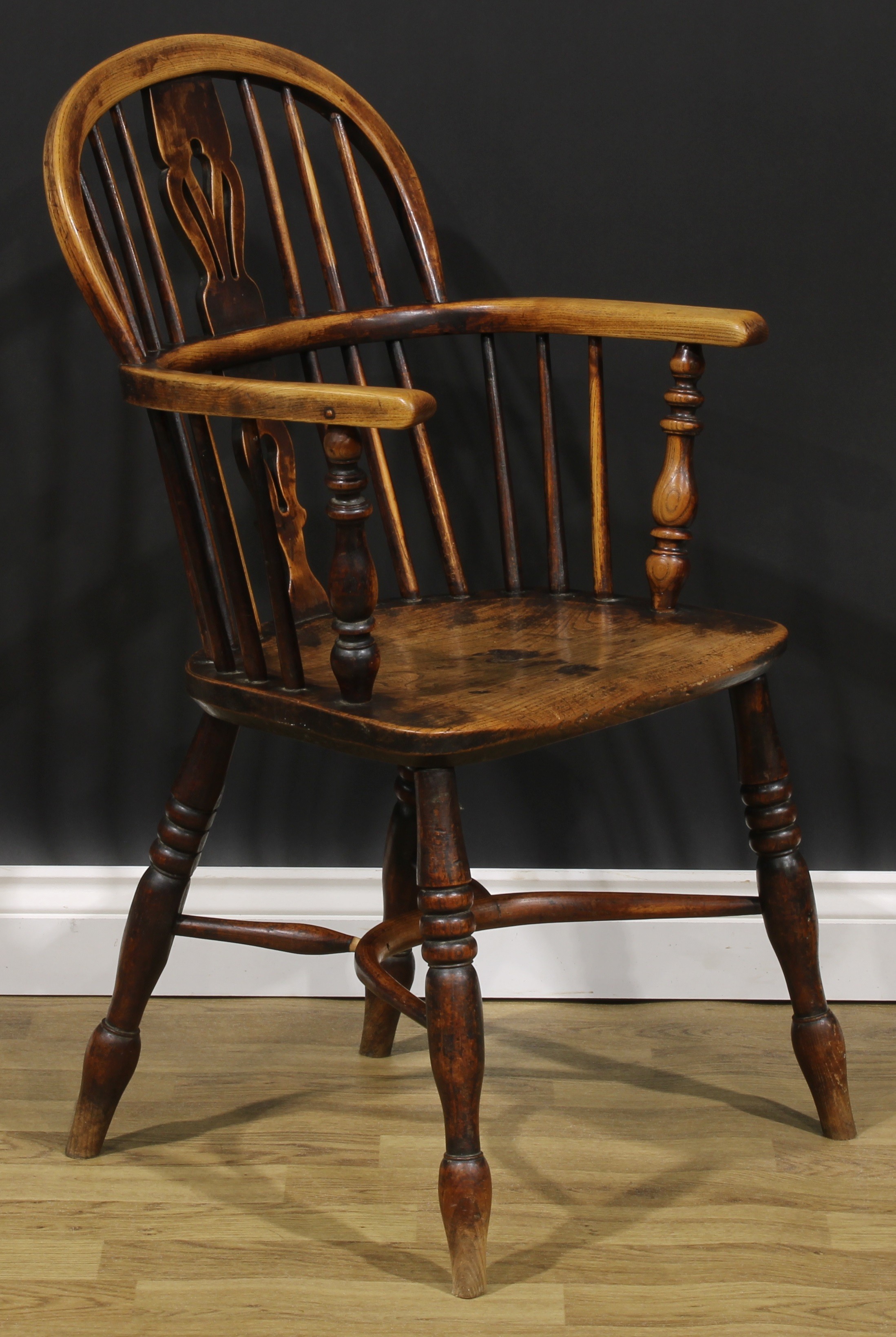 A 19th century East Midlands ash and elm Windsor elbow chair, low hoop back, shaped and pierced - Image 2 of 4