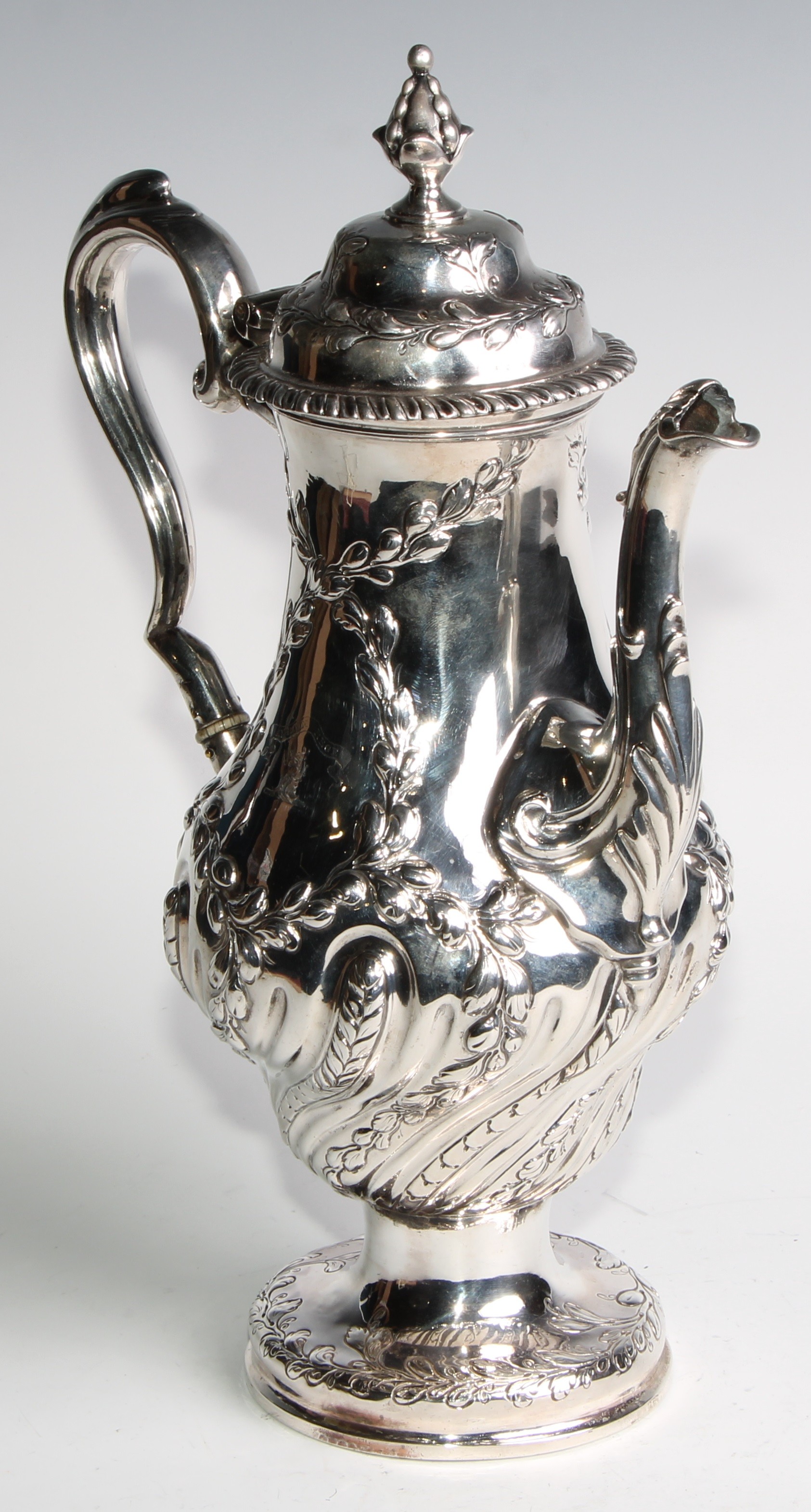 An early George III silver baluster coffee pot, wrythen half-fluted and chased with leafy - Image 3 of 6