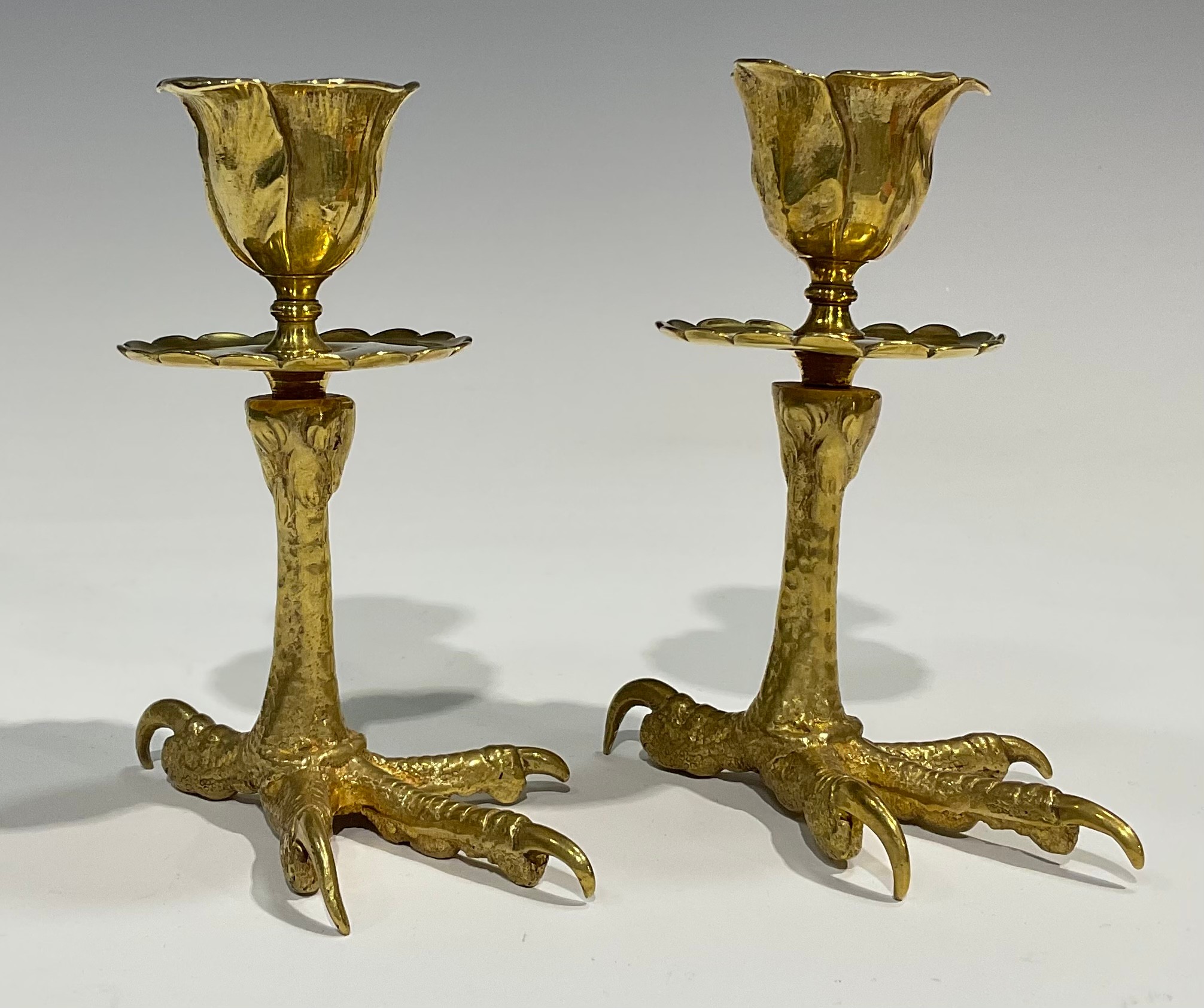 A pair of brass candlesticks, each base cast as an eagles foot, foliate moulded nozzles, shaped - Image 2 of 4