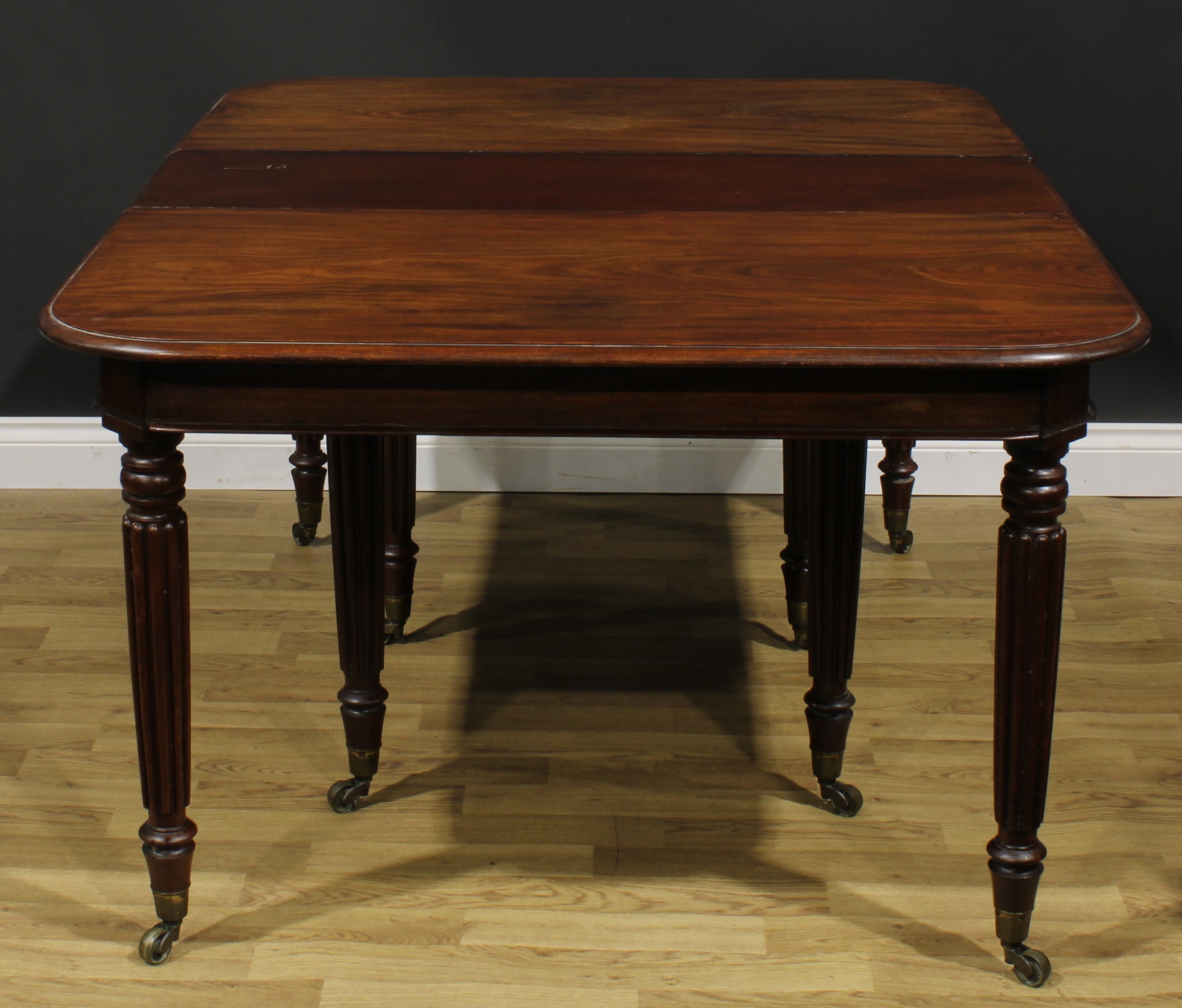 A George/William IV mahogany extending dining table, rounded rectangular top with two - Image 2 of 4