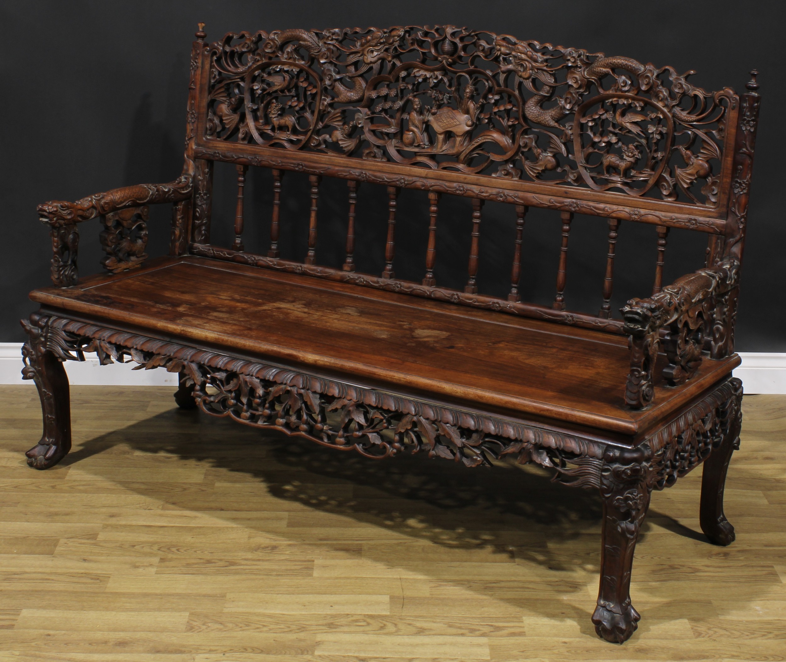 A Chinese hardwood bench or settle, arched cresting pierced and profusely carved with dragons, - Image 3 of 4