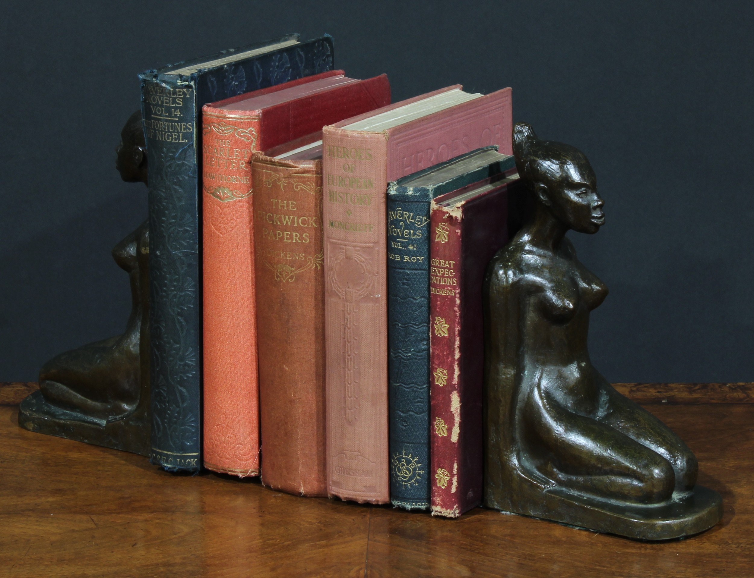 A pair of Art Deco brown patinated bronze bookends, probably Austrian, each cast as a kneeling