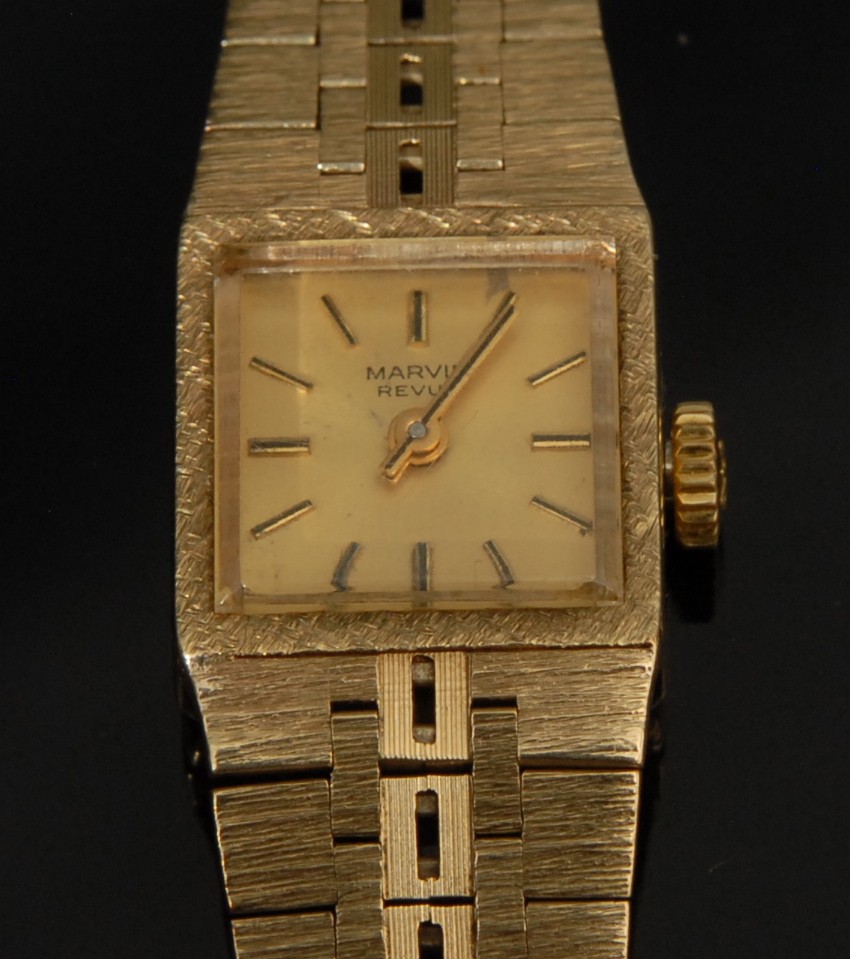 A 9ct gold Marvin Revue ladies wristwatch, square champagne dial, baton hour markers, articulated