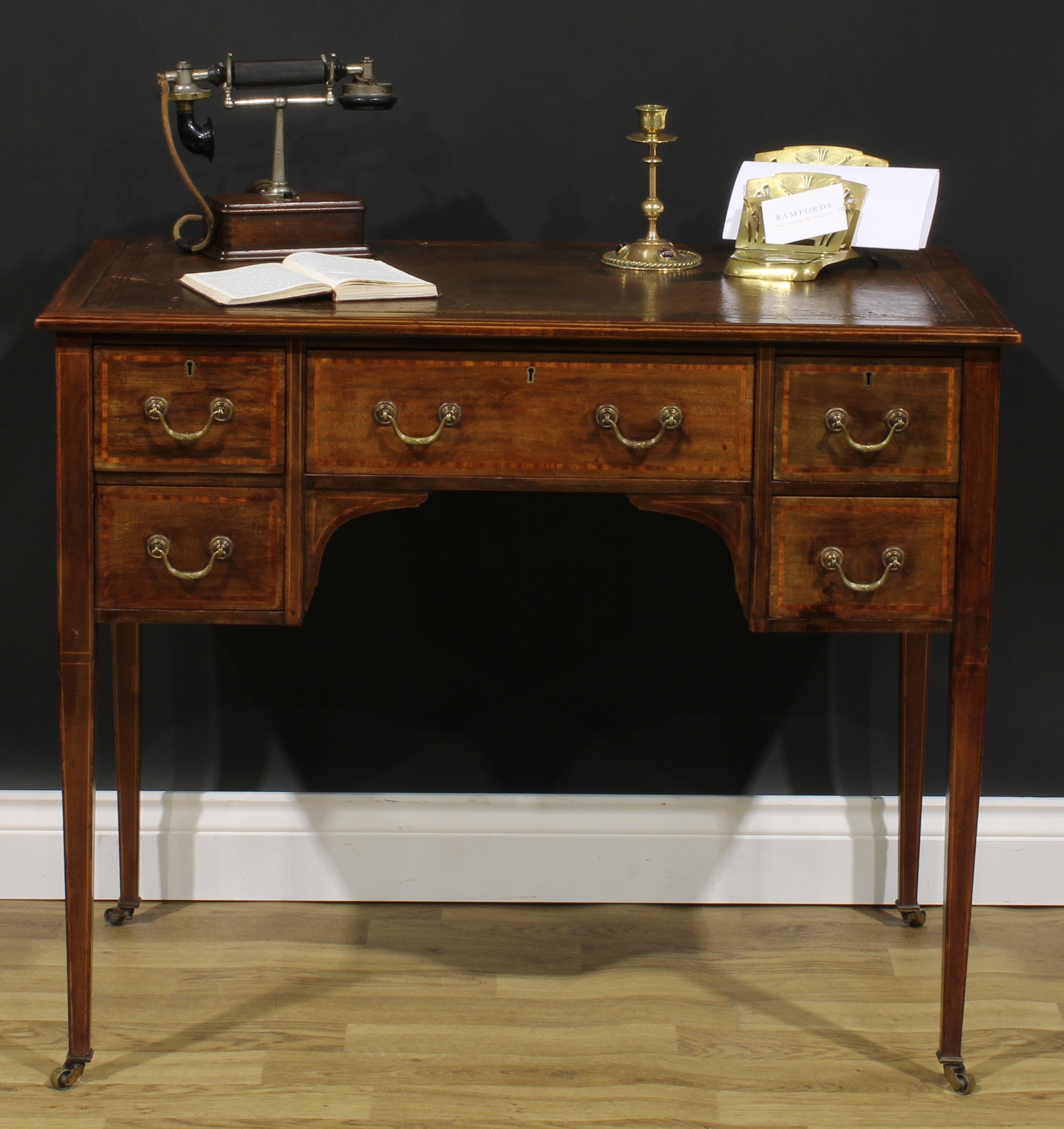 An Edwardian Sheraton Revival satinwood crossbanded mahogany desk, rectangular top with inset tooled