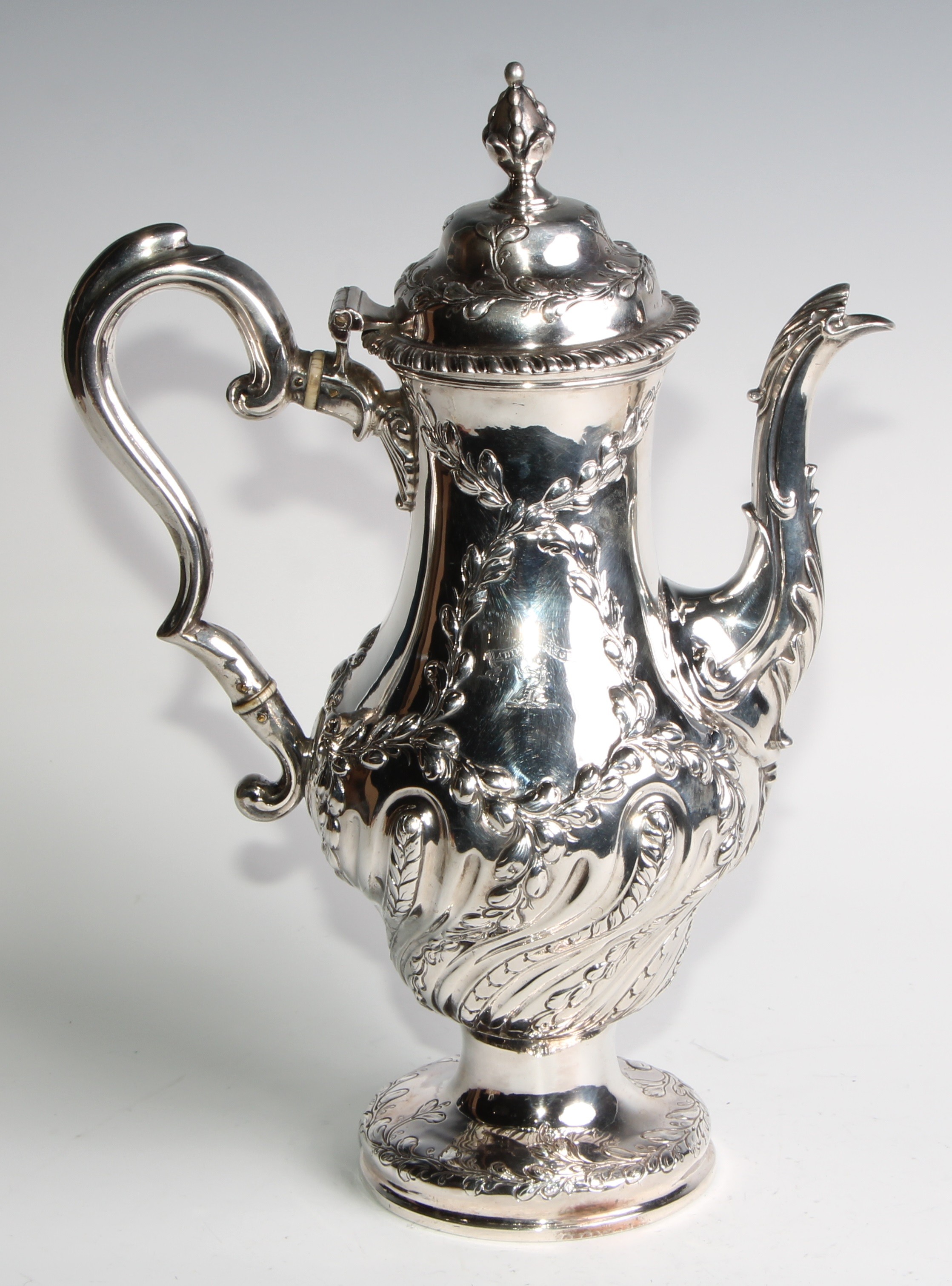 An early George III silver baluster coffee pot, wrythen half-fluted and chased with leafy - Image 2 of 6