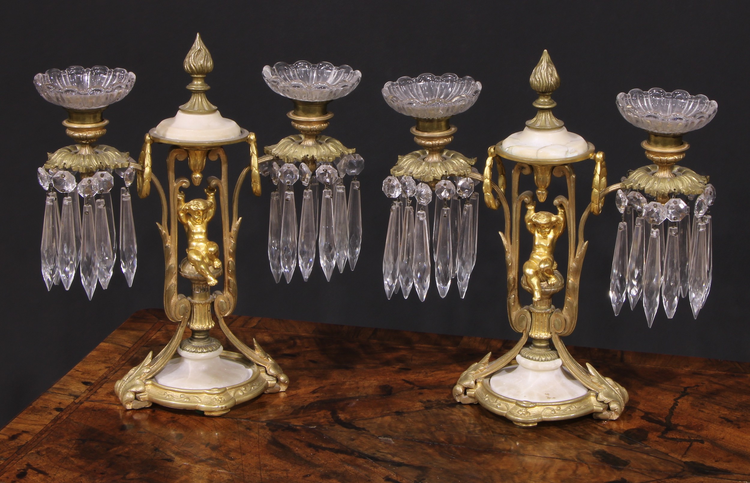 A pair of 19th century French gilt metal and alabaster two-light mantel candle lustres, each centred