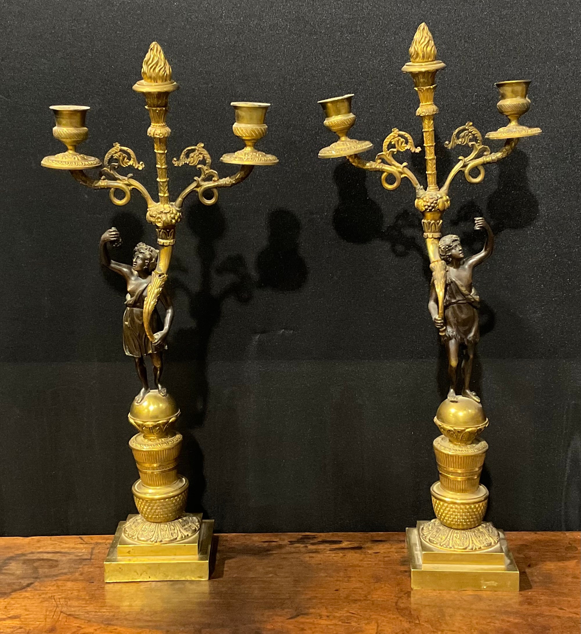 A pair of 19th century French bronze and ormolu figural two-light mantel candelabrum, each Bacchic