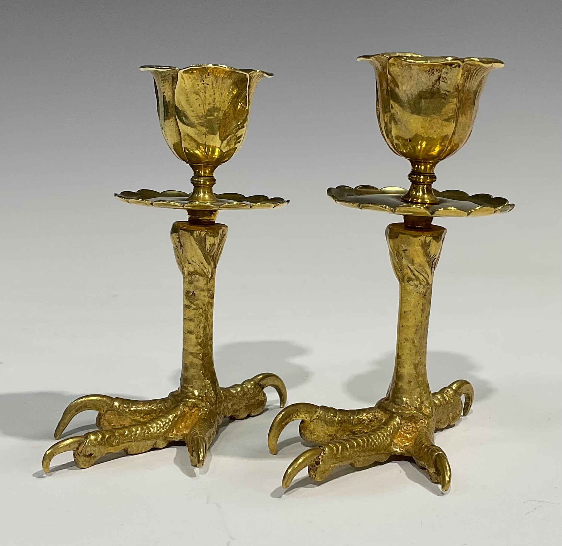 A pair of brass candlesticks, each base cast as an eagles foot, foliate moulded nozzles, shaped - Image 3 of 4