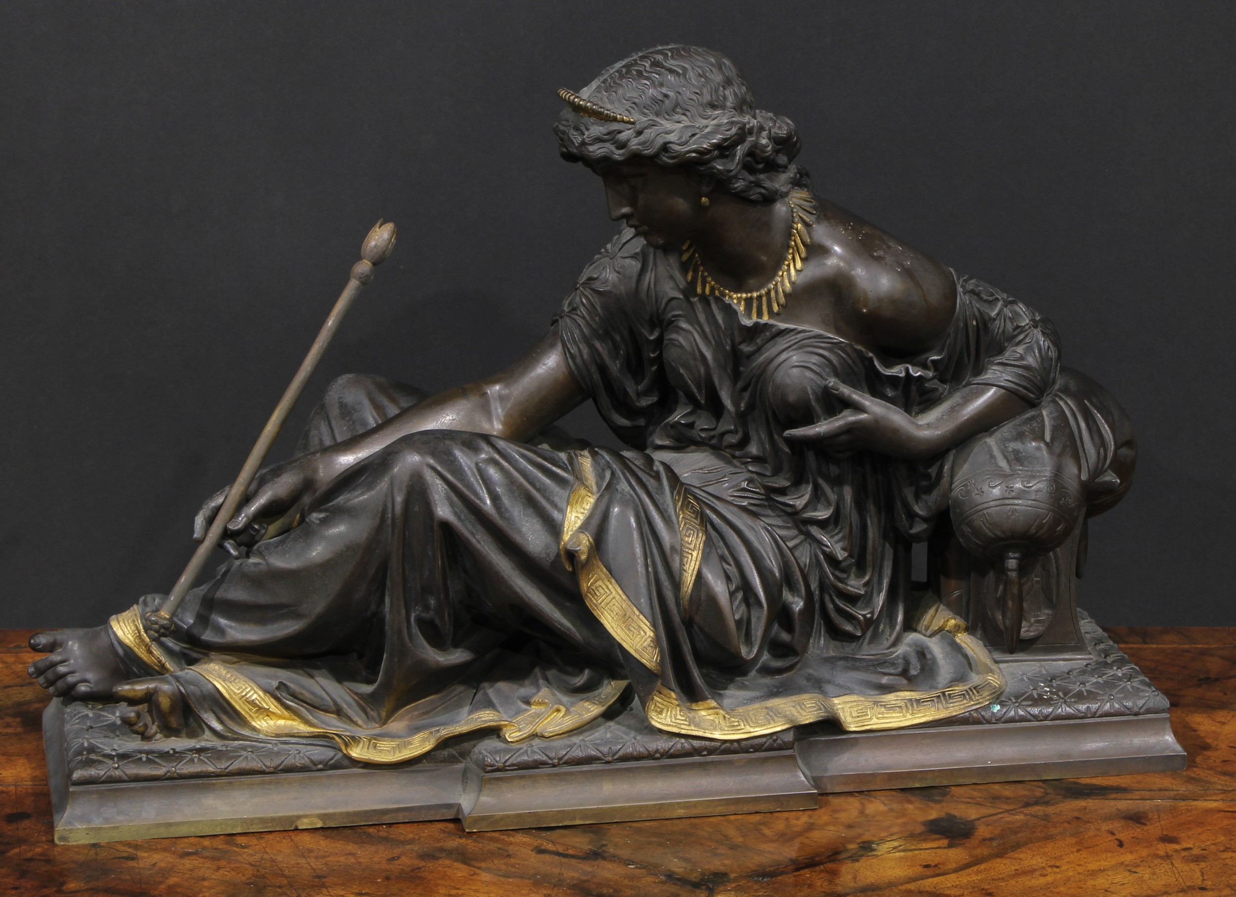 French School (19th century), a dark patinated and parcel-gilt bronze, of Diana, 48cm wide