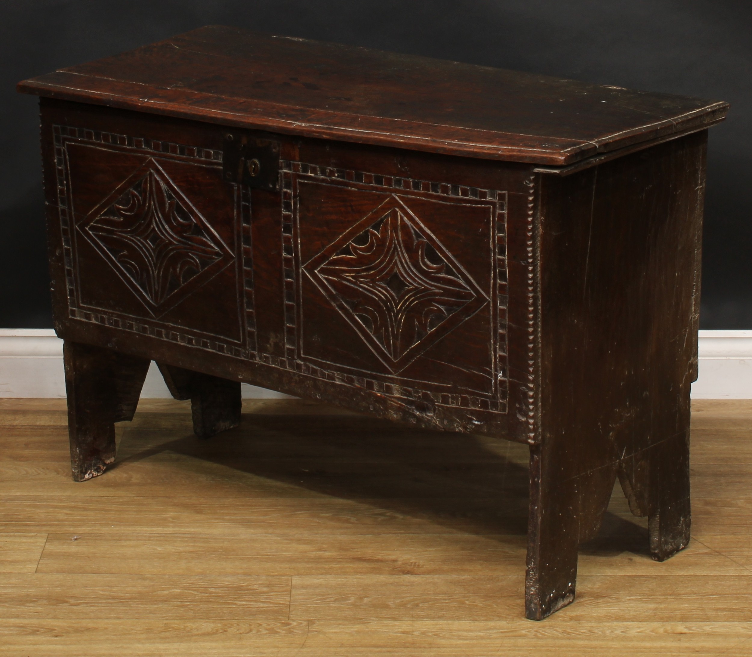 A 17th century elm six plank chest, hinged top enclosing a till, the front carved with leafy - Image 4 of 5