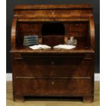 A 19th century Biedermeier flame mahogany cylinder desk, concave frieze drawer above a retractable