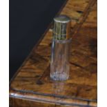 A George V silver-gilt cylindrical scent bottle, hinged cover enclosing a stopper, 7.5cm high,