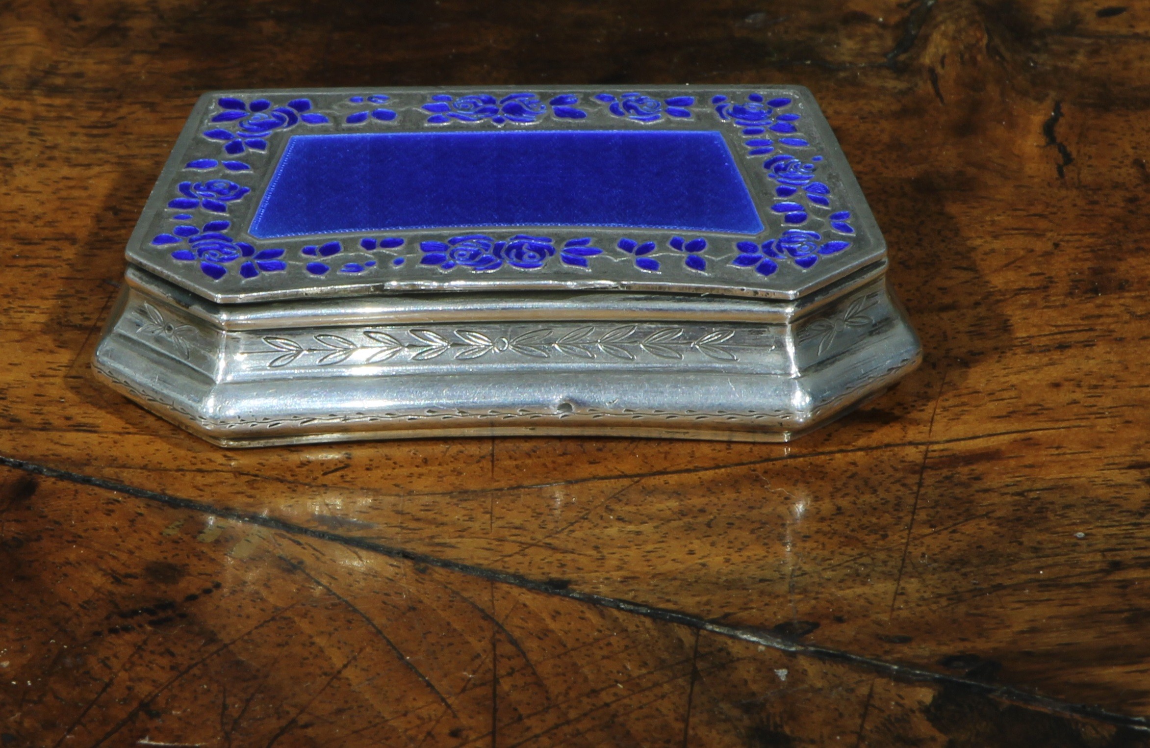 An early 20th century French silver and enamel lozenge shaped snuff box, hinged cover with blue