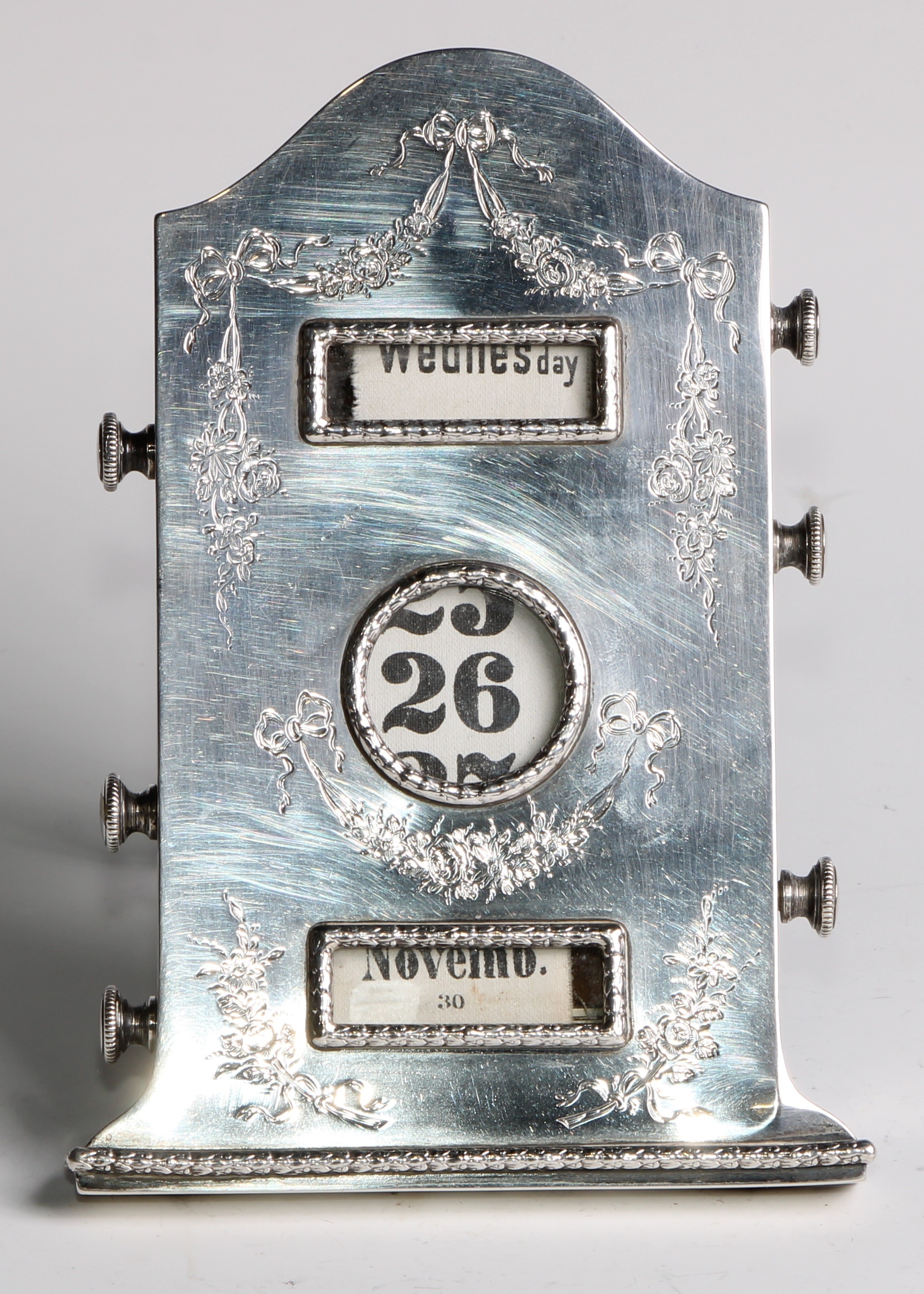An Edwardian silver arched rectangular easel perpetual desk calendar, engraved in the Neo- - Image 2 of 4