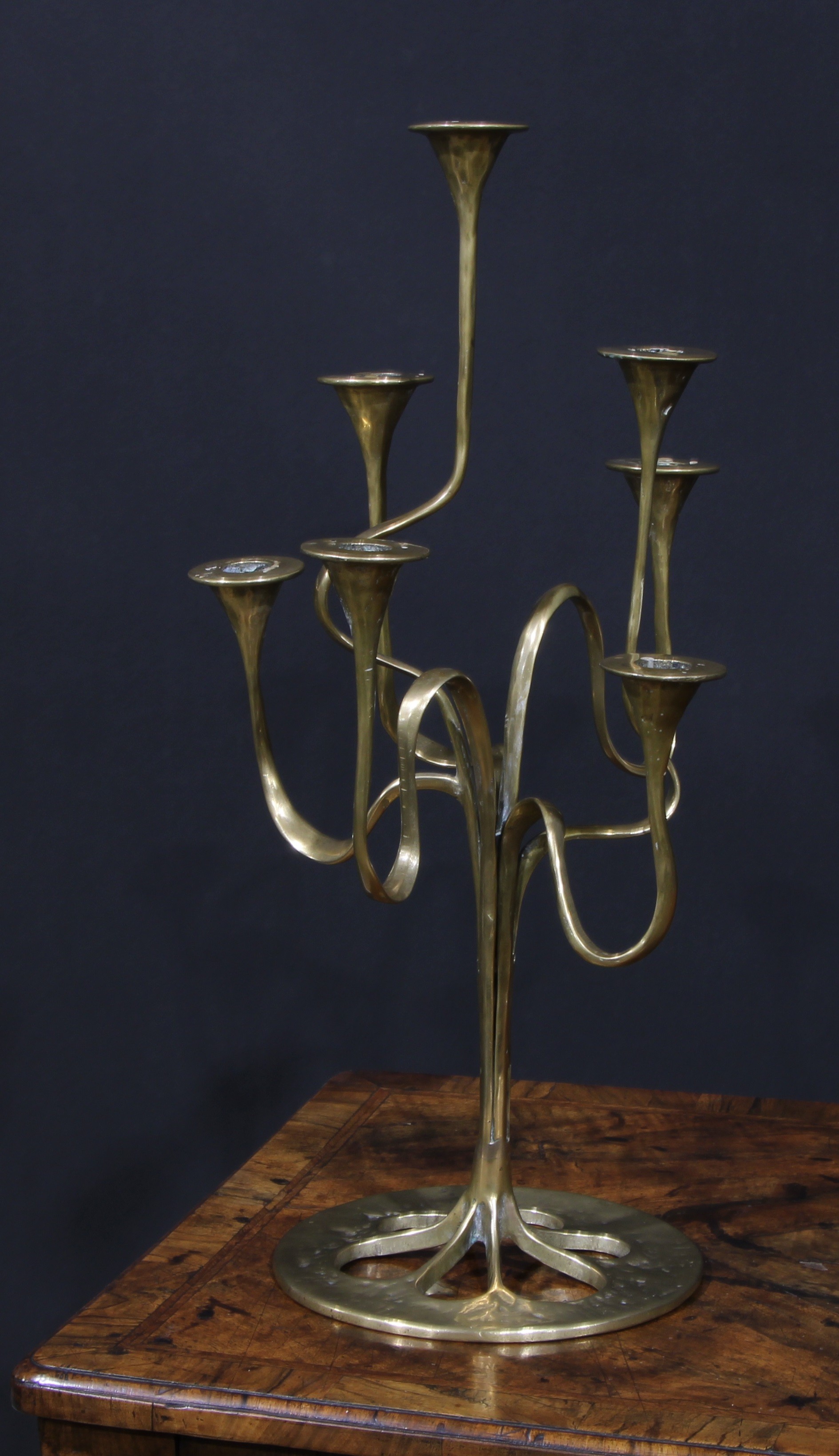 A Jugendstil or Art Nouveau style brass seven-light candelabrum, possibly Bäckhaus Solingen, sinuous