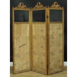 A Louis XVI Revival giltwood and gesso three-fold screen, each bevelled quarter-glazed panel crested