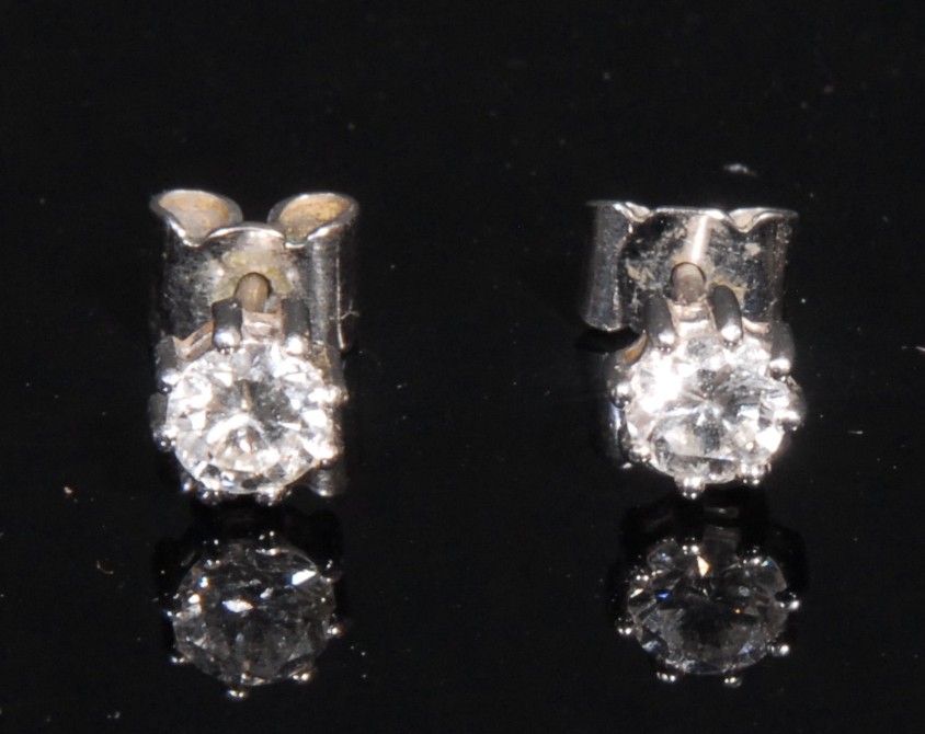 A pair of round brilliant cut diamond and 18ct white gold ear studs, ear diamond approximately 0.