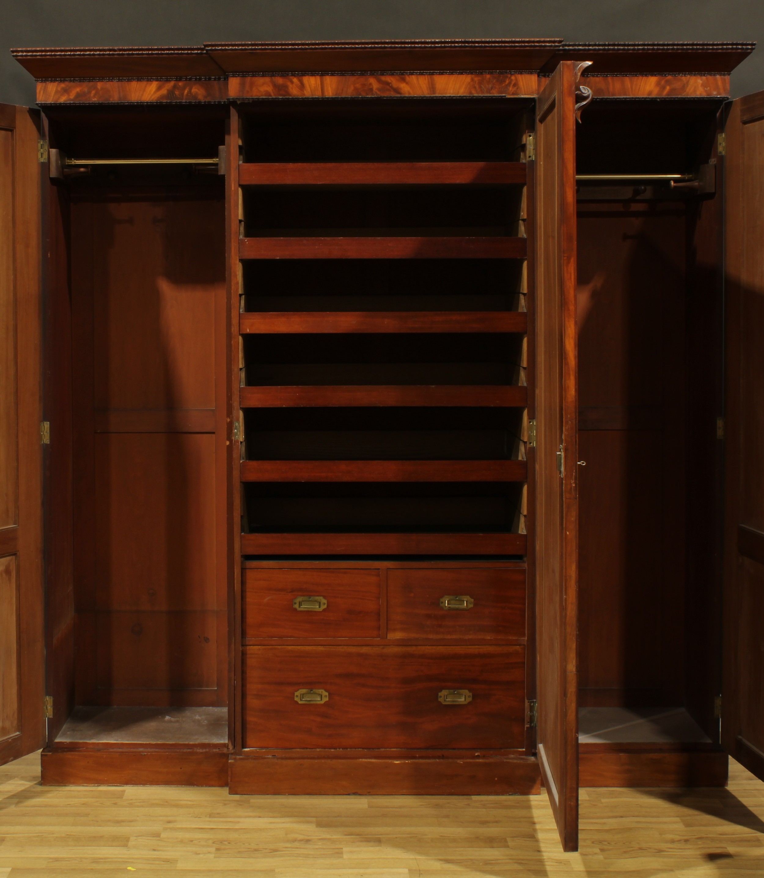 A Victorian mahogany break-centre wardrobe, outswept cornice with reel edge above three panel doors, - Image 2 of 2