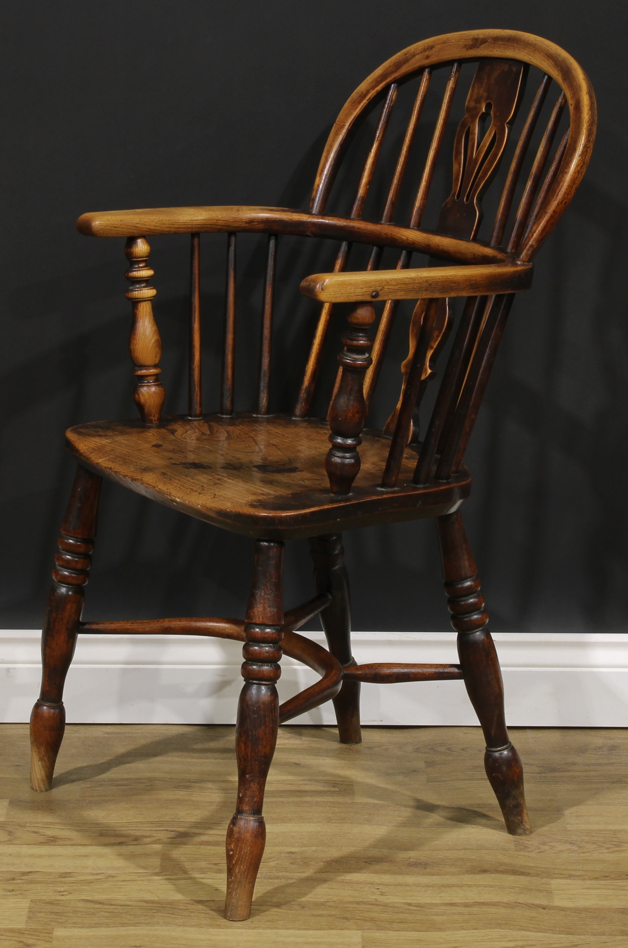 A 19th century East Midlands ash and elm Windsor elbow chair, low hoop back, shaped and pierced - Image 3 of 4