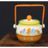 A Clarice Cliff Crocus pattern biscuit barrel and cover, painted in bright colours, wicker handle,