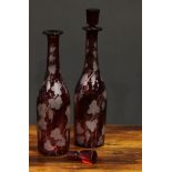 A pair of Bohemian ruby flashed glass decanters, etched with spiralling fruiting vine, 35cm high,