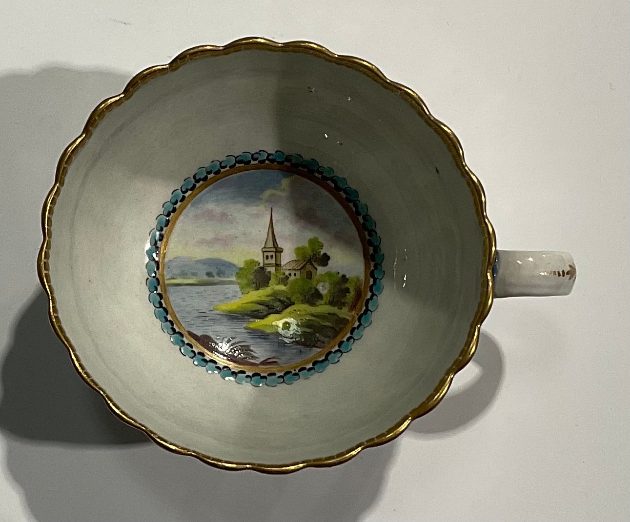 A Worcester fluted teacup and saucer, circular cartouches painted with lakeside scenes, edged with a - Image 5 of 11