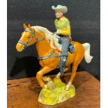 A Beswick model of a Canadian Mounted Cowboy on a galloping Palomino horse, number 1377, 22.5cm,