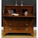 A George III mahogany bureau, fall front enclosing a fitted interior, above four long graduated