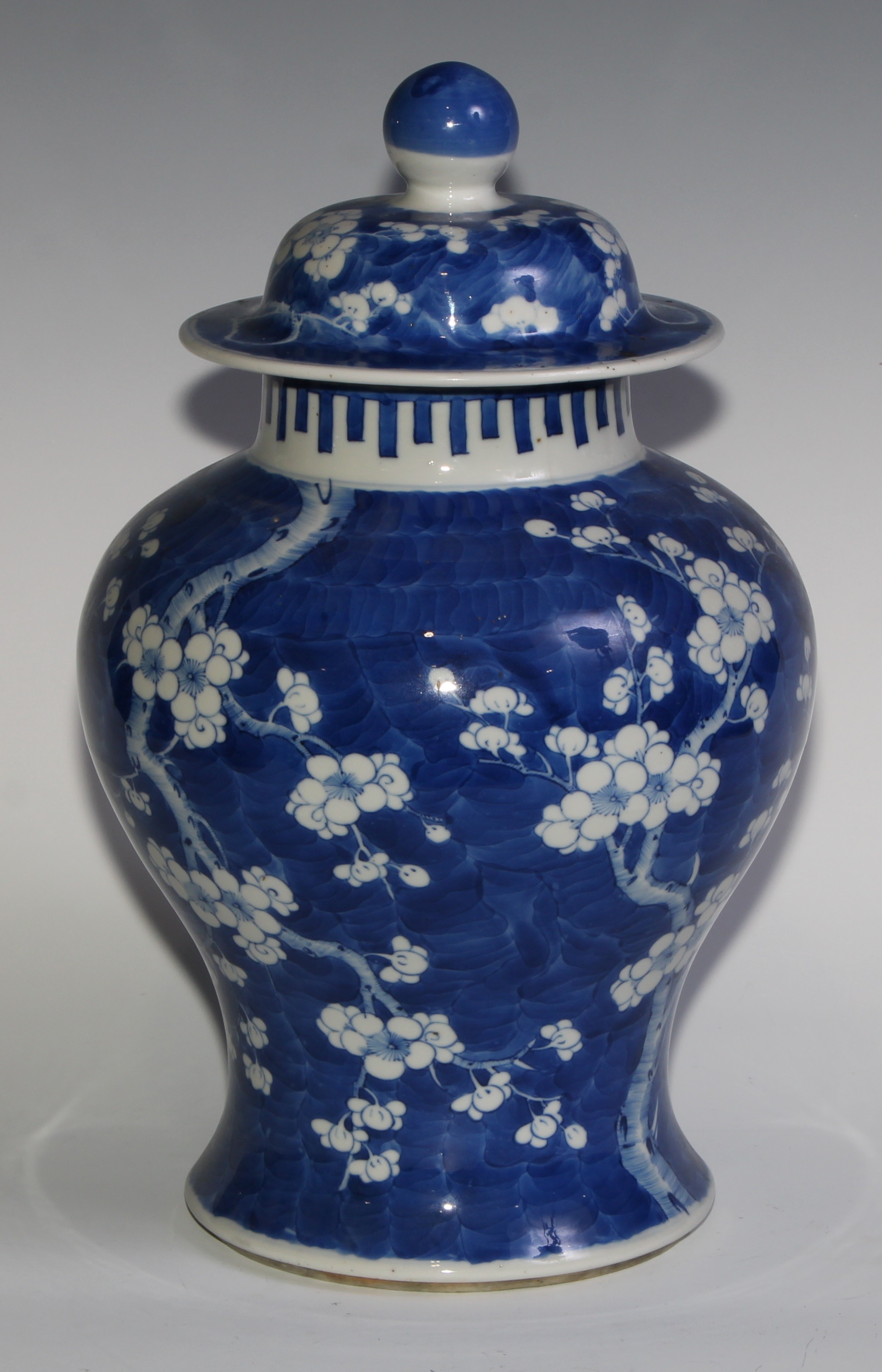 A Chinese baluster jar and cover, painted in tones of underglaze blue with blossoming prunus on a - Image 2 of 6