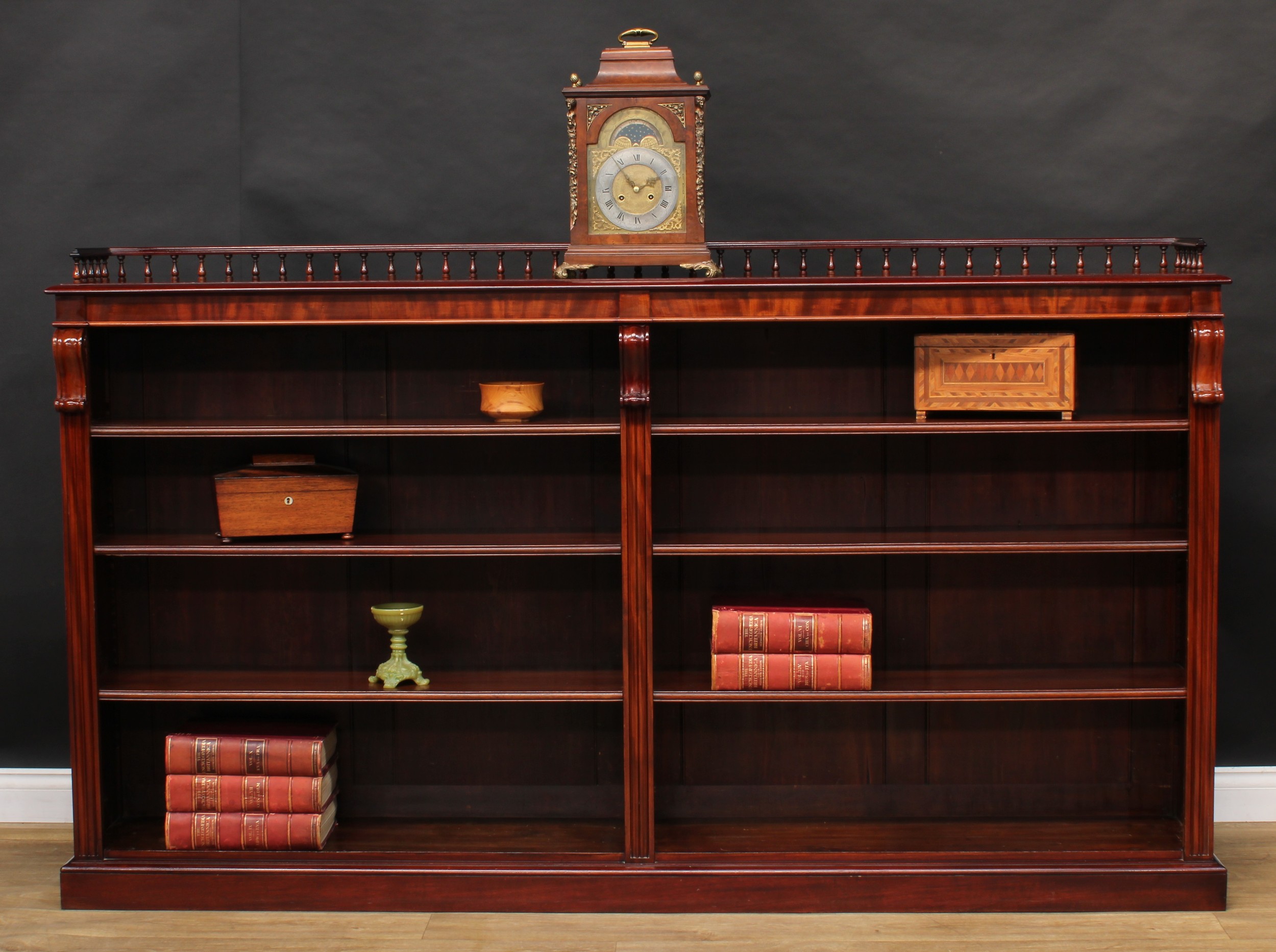 A Victorian mahogany low library bookcase, three quarter balustrade gallery above six adjustable