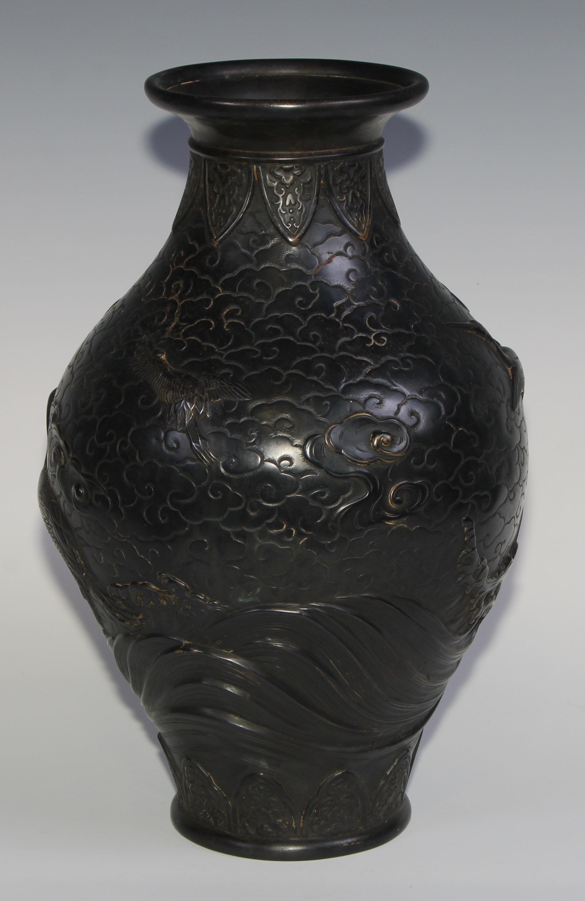 A Japanese dark patinated bronze ovoid vase, cast in relief with cranes taking flight amongst - Image 4 of 7