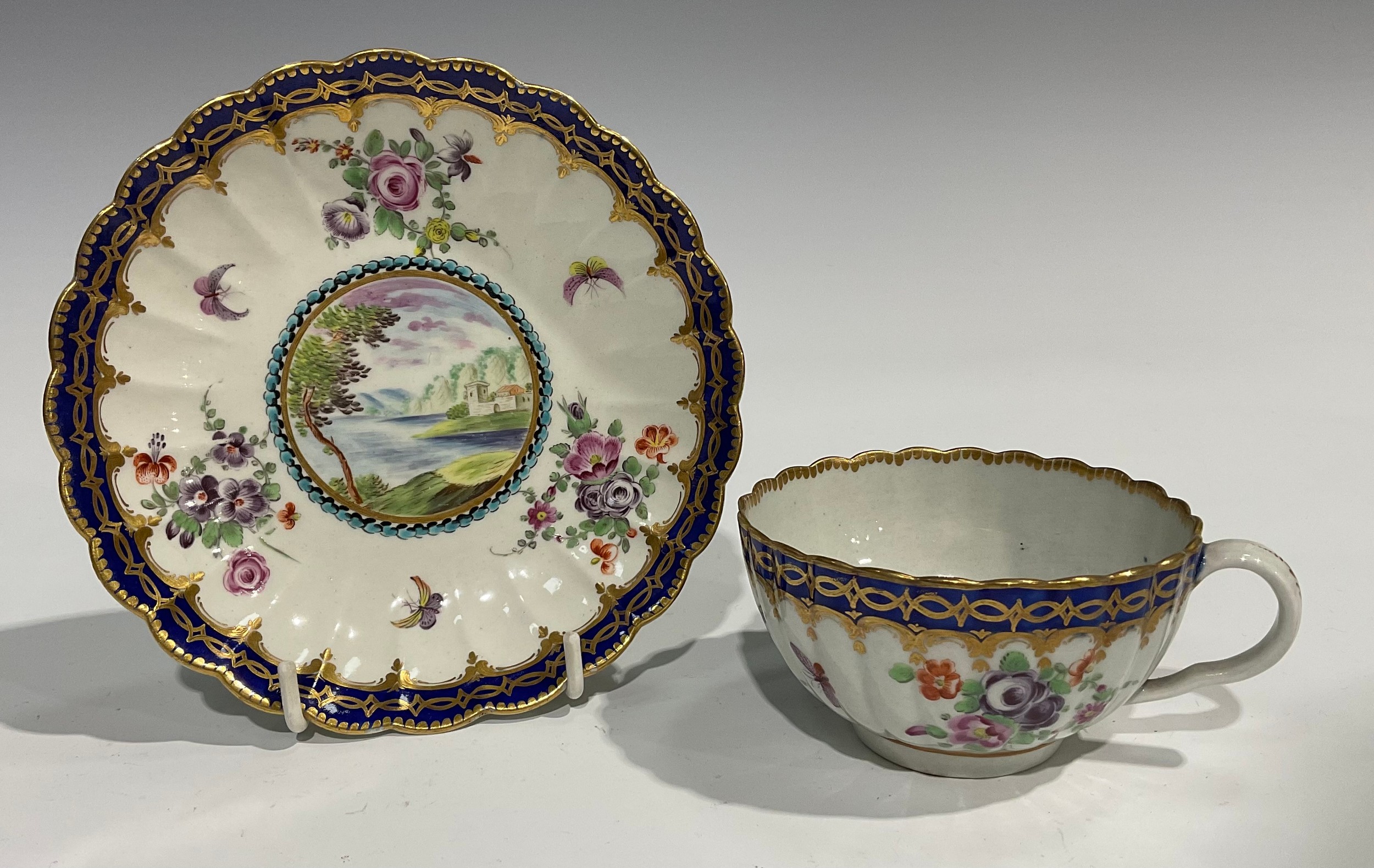 A Worcester fluted teacup and saucer, circular cartouches painted with lakeside scenes, edged with a - Image 4 of 11