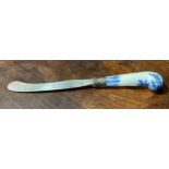A Bow porcelain knife handle, pistol grip, painted in underglaze blue with foliate tendrils and